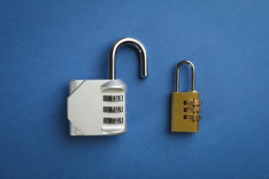 Photo of Different combination locks on blue background, flat lay