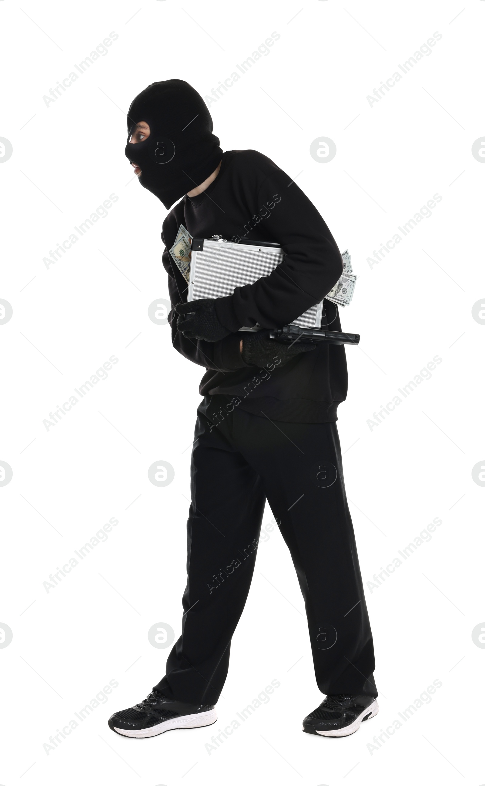 Photo of Thief in balaclava with gun and briefcase of money on white background