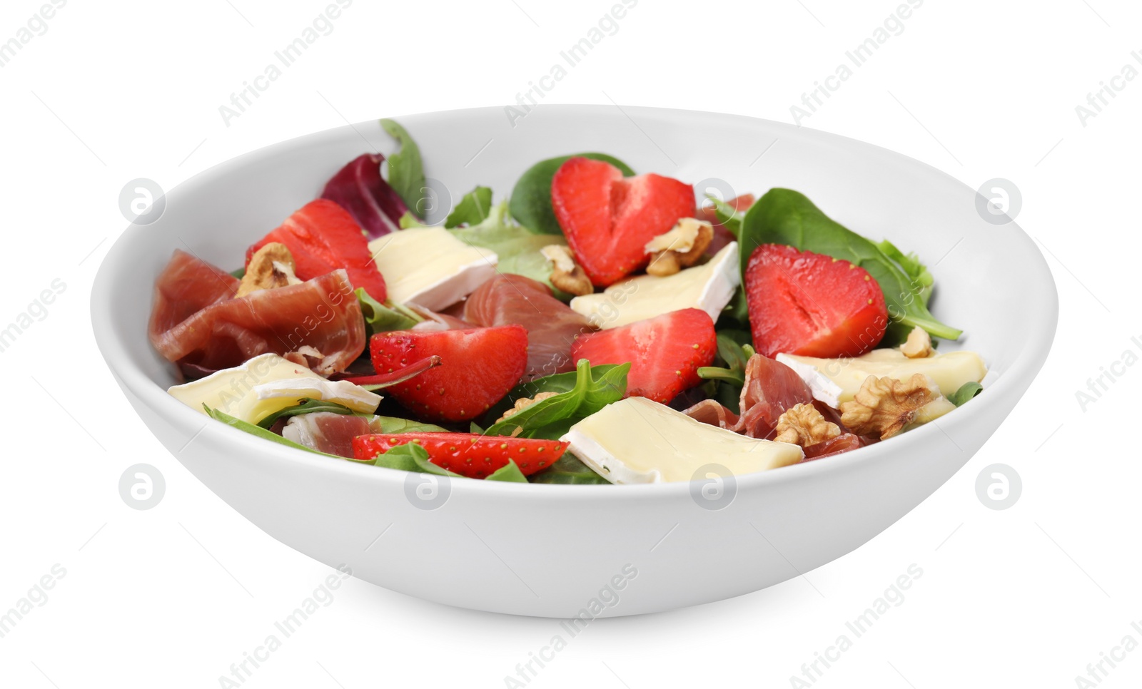 Photo of Tasty salad with brie cheese, prosciutto, strawberries and walnuts isolated on white