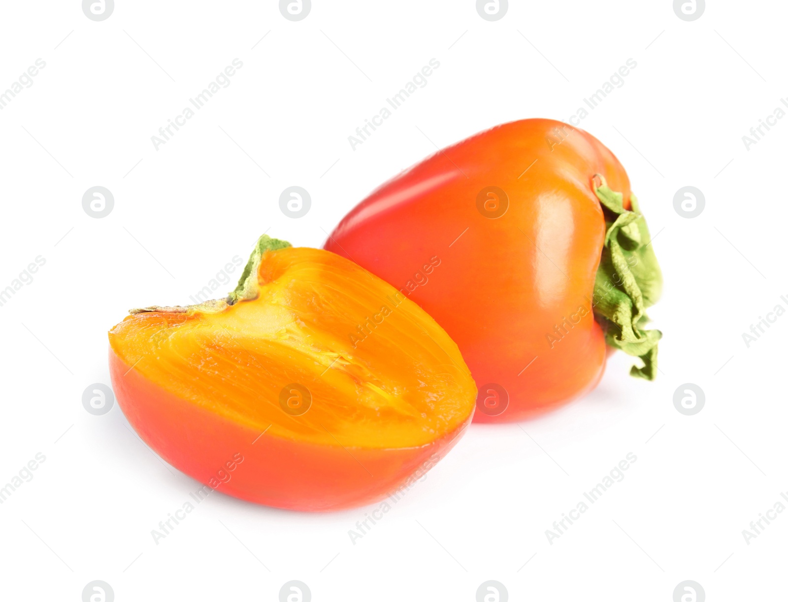 Photo of Delicious cut and whole fresh ripe persimmons isolated on white