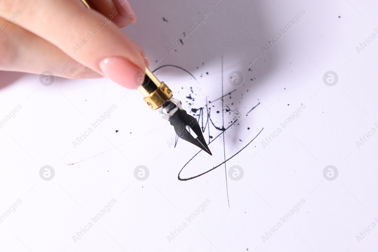 Photo of Woman signing on sheet of paper with fountain pen, closeup