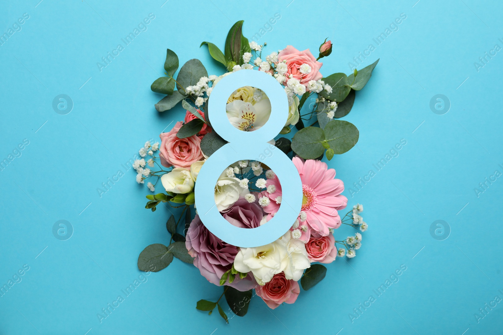 Photo of 8 March greeting card design with beautiful flowers on light blue background, flat lay. International Women's day