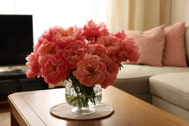 Photo of Beautiful pink peonies in vase on table at home. Interior design