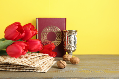 Photo of Composition with Passover matzos on wooden table. Pesach celebration