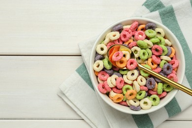 Photo of Bowl of sweet crispy corn rings on white wooden table, flat lay with space for text. Breakfast cereal