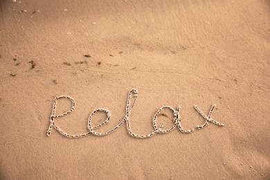 Photo of Sandy beach with written word Relax in summer, above view