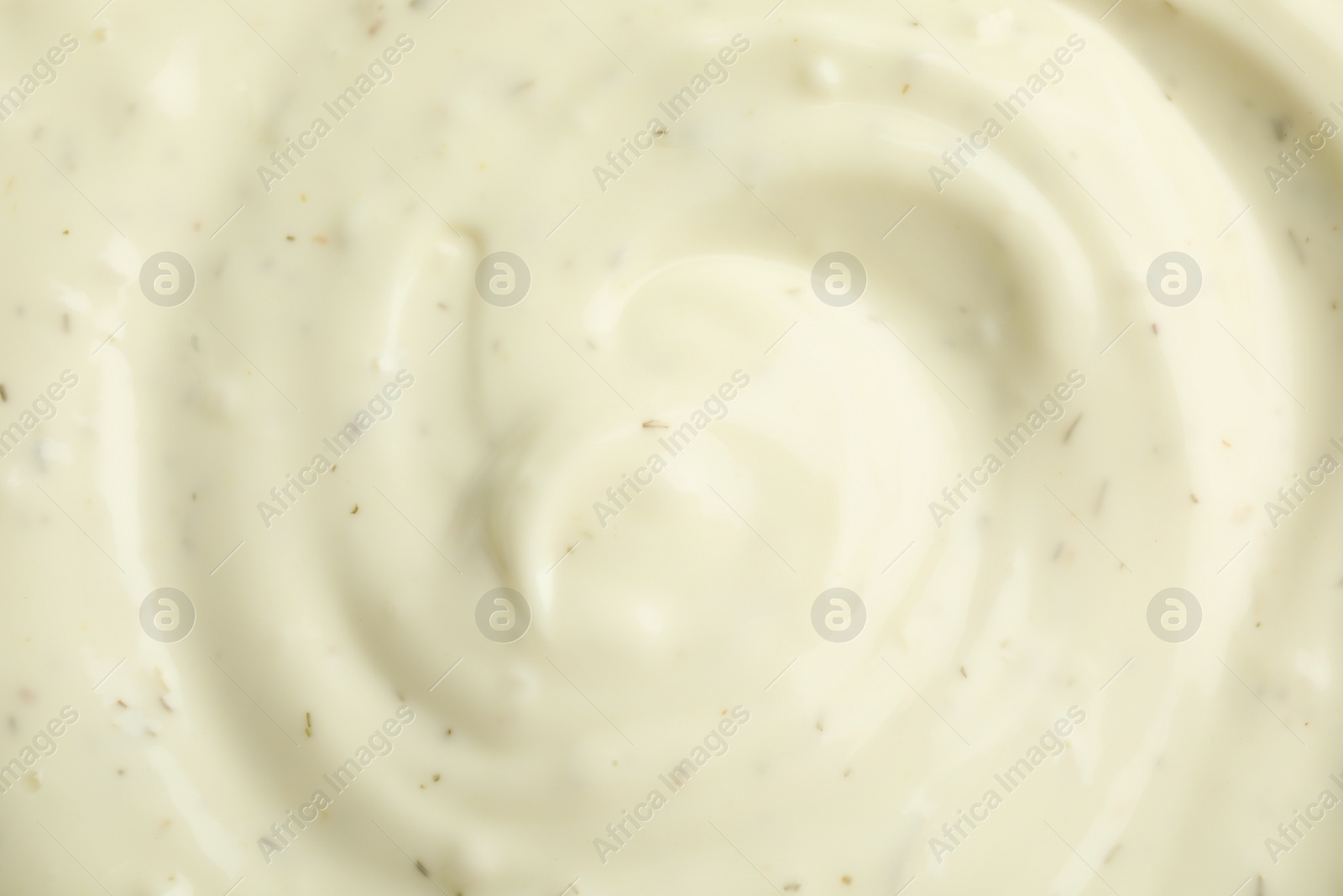 Photo of Tasty homemade garlic sauce as background, top view