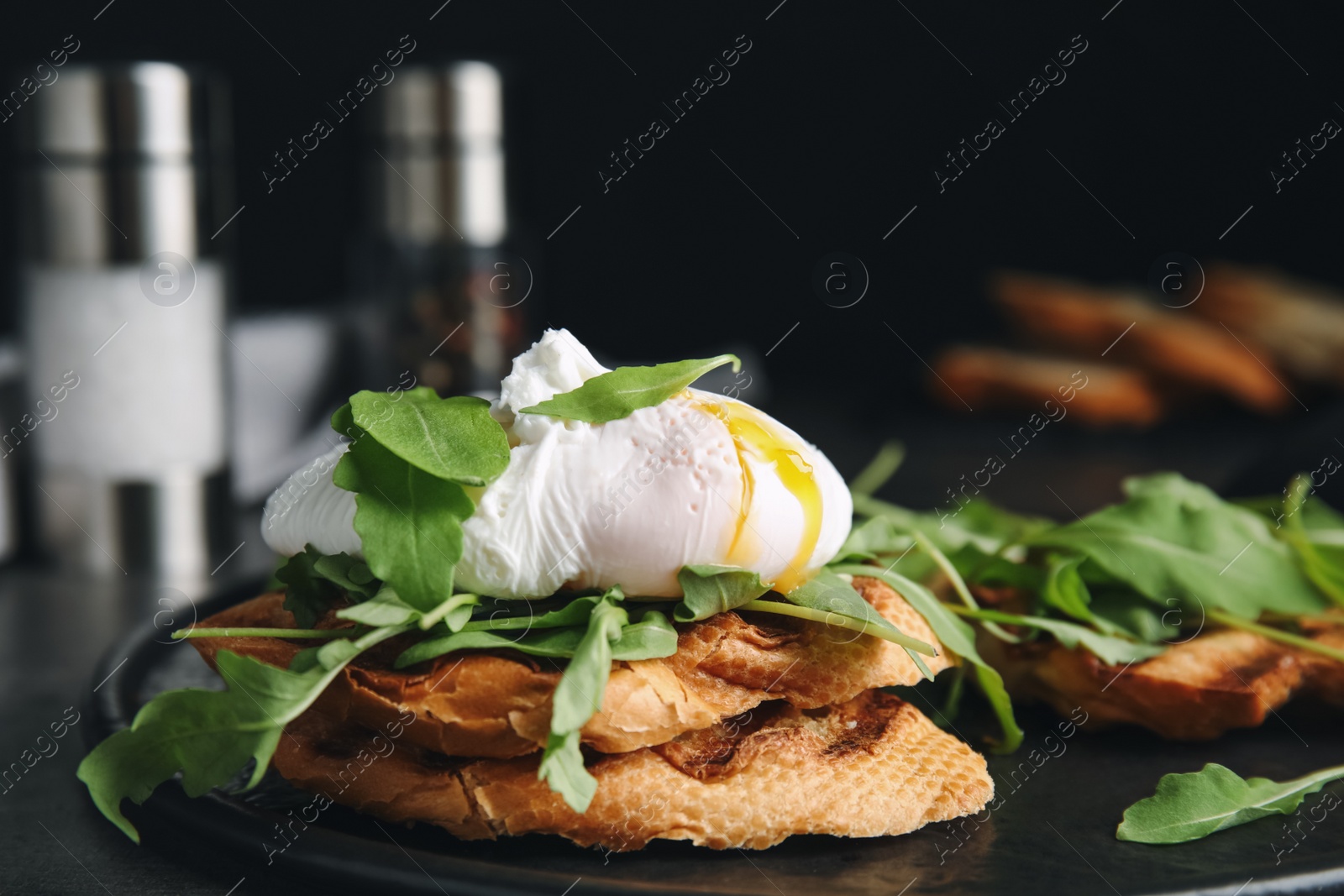 Photo of Delicious sandwich with arugula and egg on table, closeup