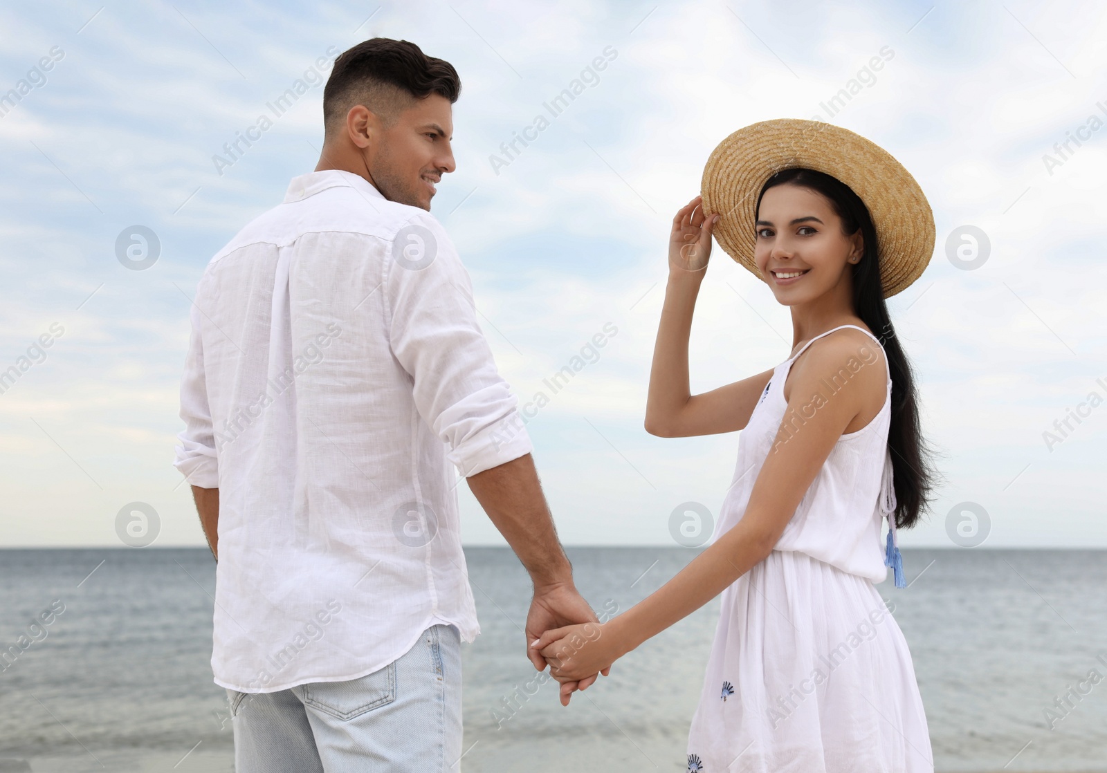 Photo of Lovely couple spending time together on beach