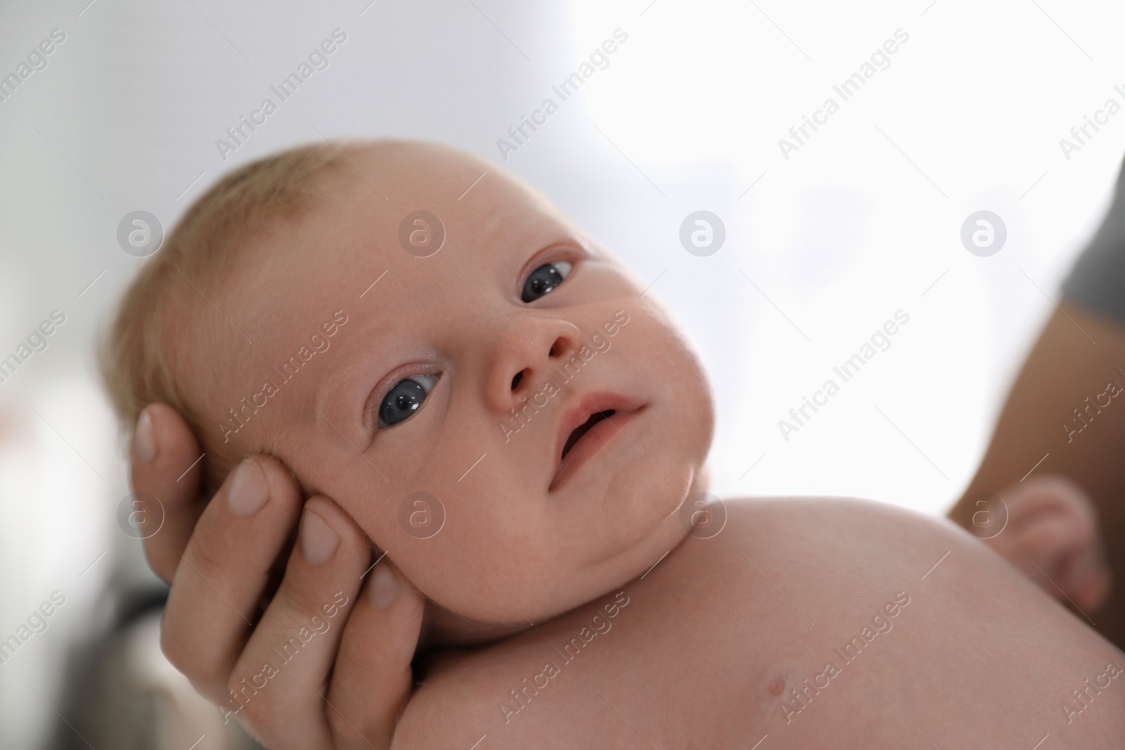 Photo of Father holding his little baby in bedroom, closeup