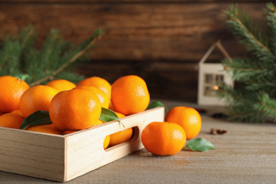 Tasty fresh tangerines on wooden table. Christmas celebration