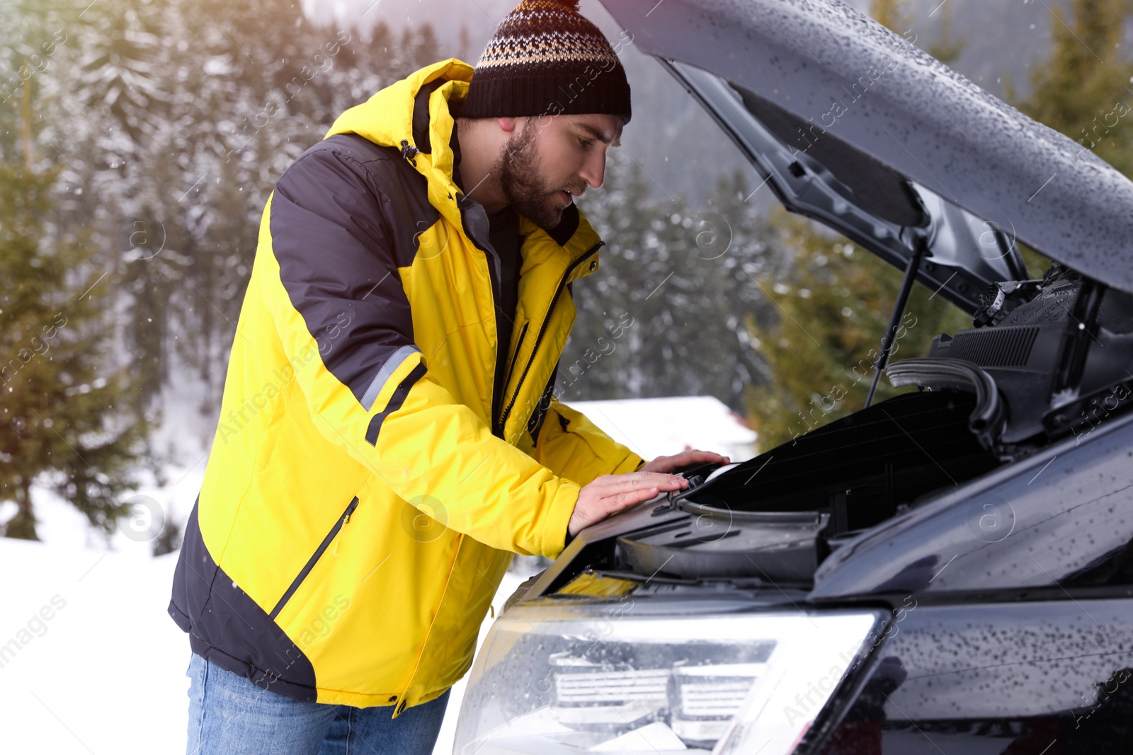 Photo of Stressed man near broken car outdoors on winter day