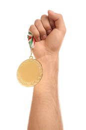 Man holding golden medal on white background, closeup. Space for design