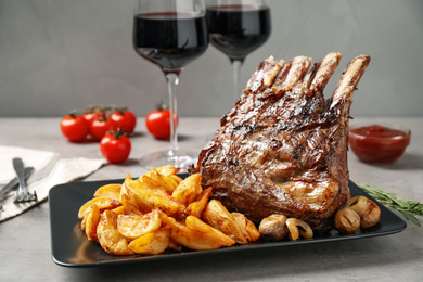 Delicious grilled ribs served on light grey table