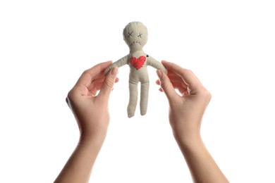 Woman holding voodoo doll with pin in heart on white background, closeup