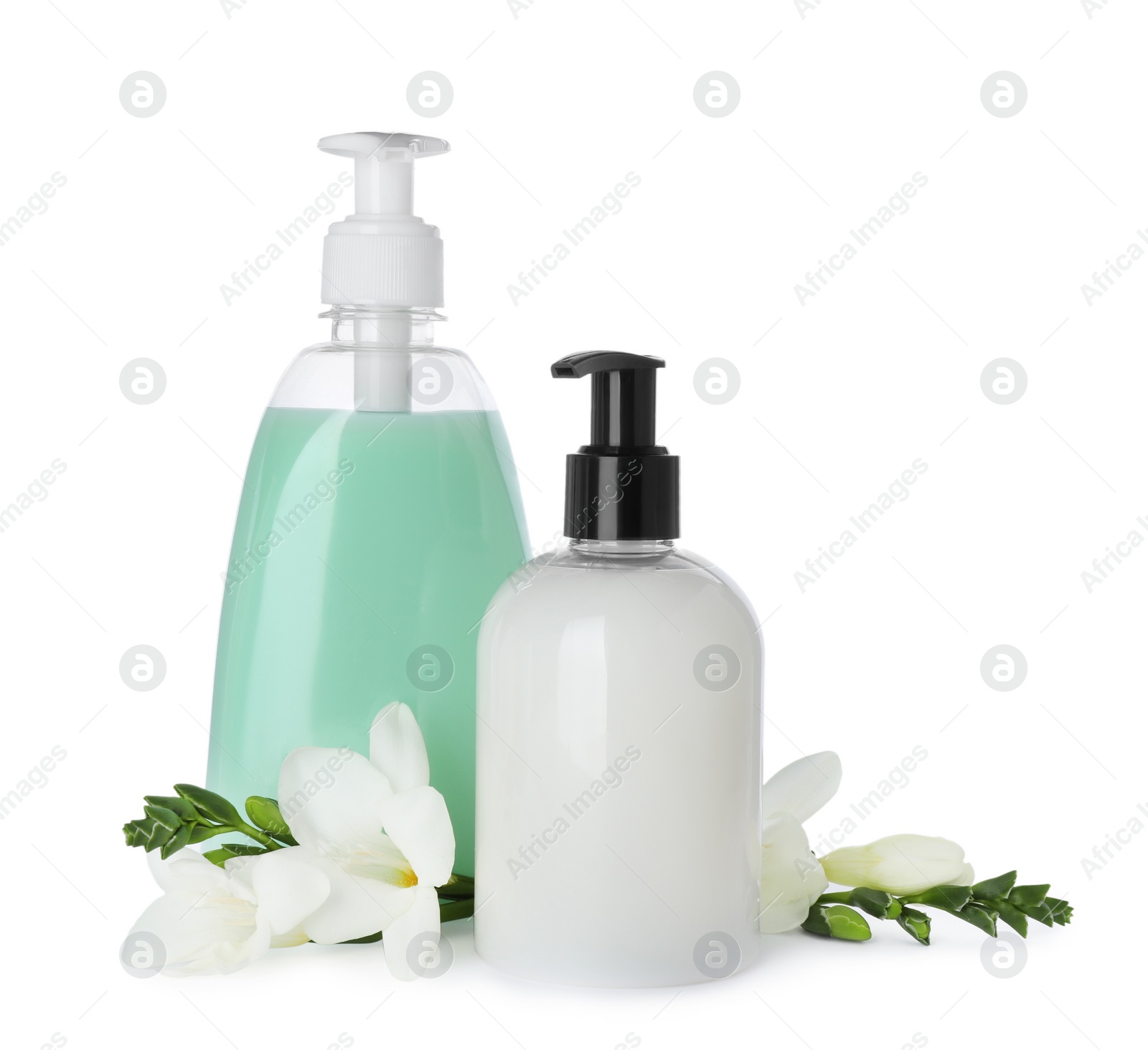 Photo of Dispensers of liquid soap and freesia flowers on white background