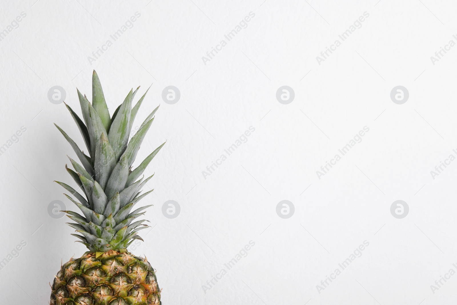 Photo of Whole ripe pineapple on white background. Space for text
