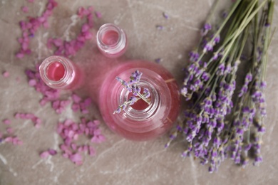 Flat lay composition with aromatic lavender oil on grey background