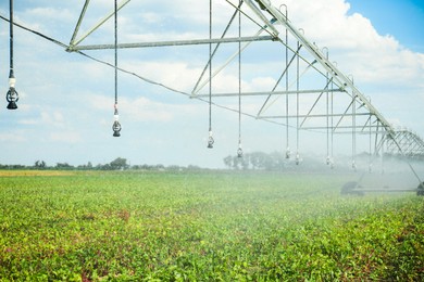 Photo of Center pivot irrigation system watering agricultural field 