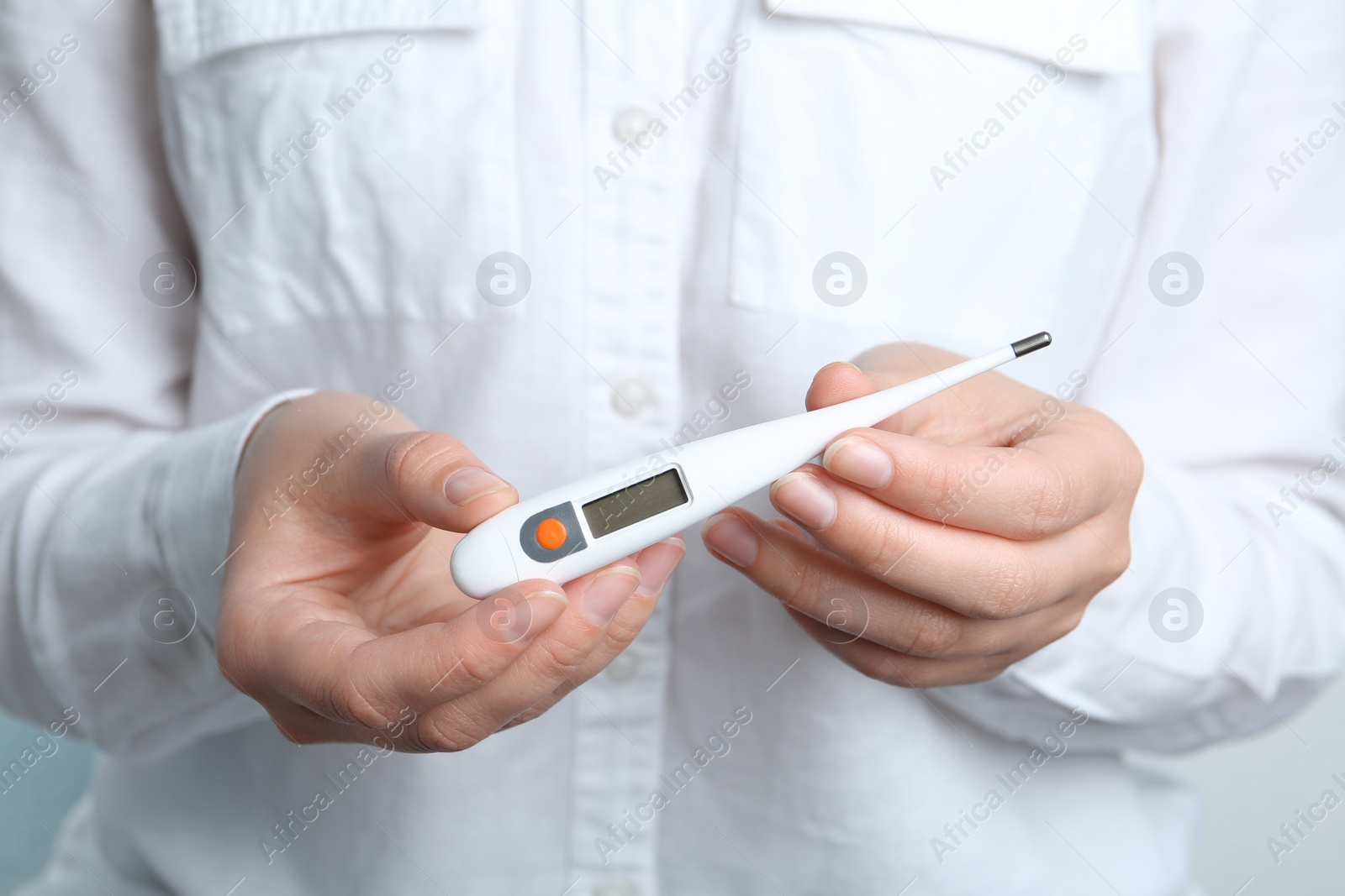 Photo of Woman holding modern digital thermometer, closeup view