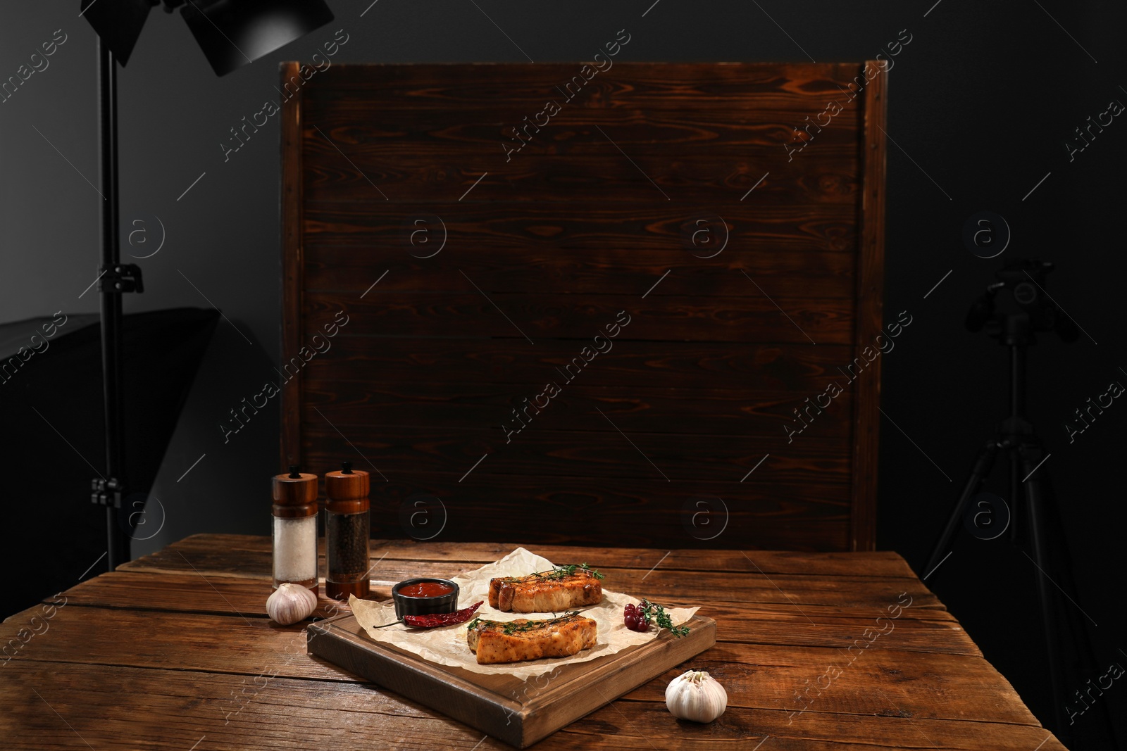 Photo of Professional equipment and composition with meat medallions on table in studio. Food photography