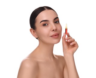 Beautiful young woman holding skincare ampoule on white background