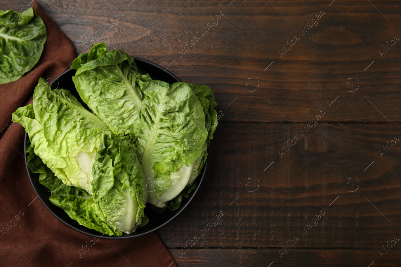 Photo of Fresh green romaine lettuces on wooden table, flat lay. Space for text