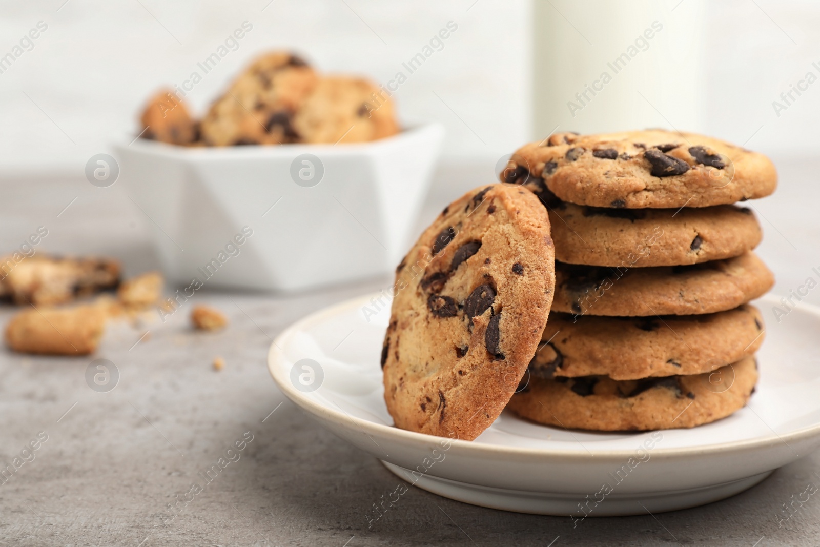 Photo of Plate with tasty chocolate cookies on gray table