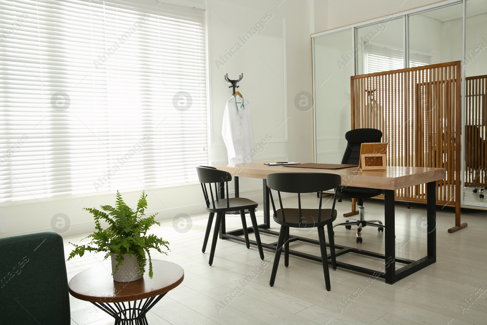 Photo of Modern medical office interior with doctor's workplace