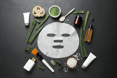 Photo of Flat lay composition with different cosmetic products and aloe on black table