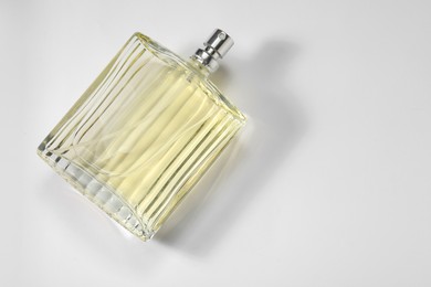 Luxury men`s perfume in bottle on white background, top view. Space for text