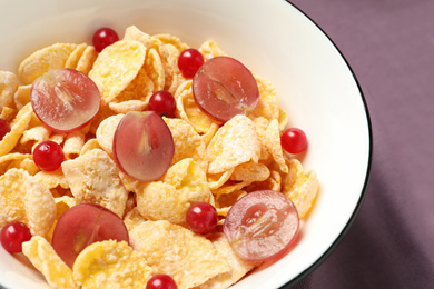 Corn flakes with berries on table, closeup. Healthy breakfast