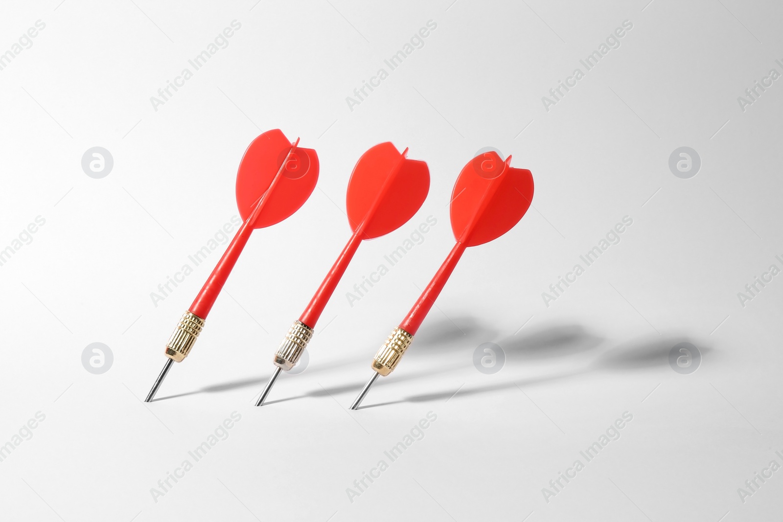 Photo of Red dart arrows for game on white background