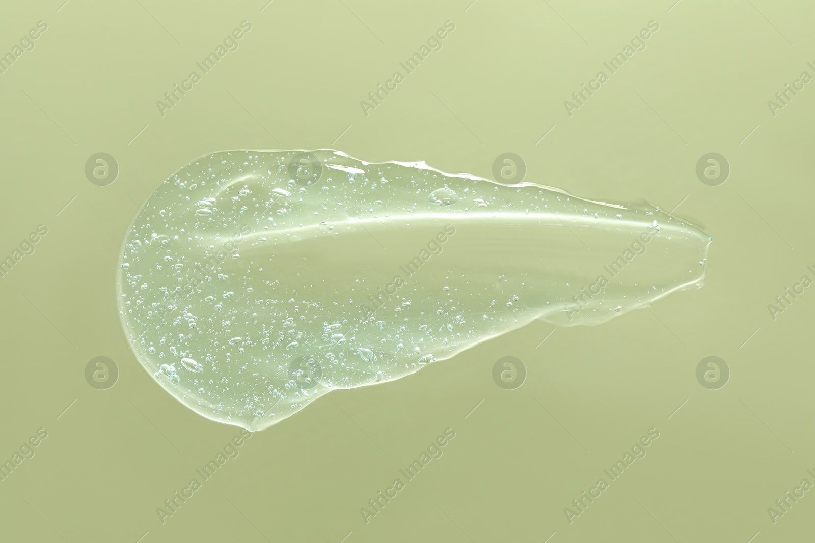 Photo of Sample of cleansing gel on pale green background, top view. Cosmetic product