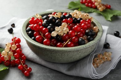 Photo of Different fresh ripe currants on light grey table, closeup