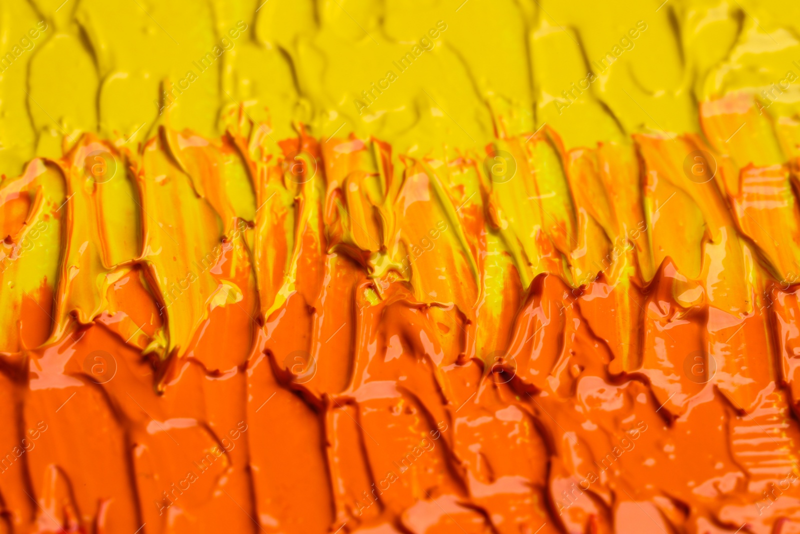 Photo of Beautiful strokes of colorful oil paints as background, closeup