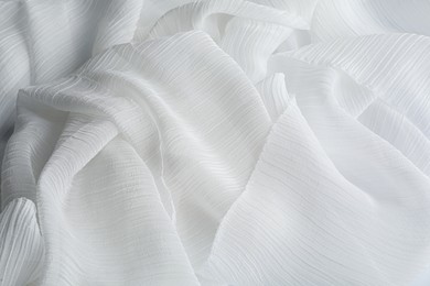 Photo of Beautiful white tulle fabric as background, closeup
