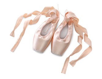 Photo of Beautiful beige ballet shoes with cute ribbons isolated on white, top view