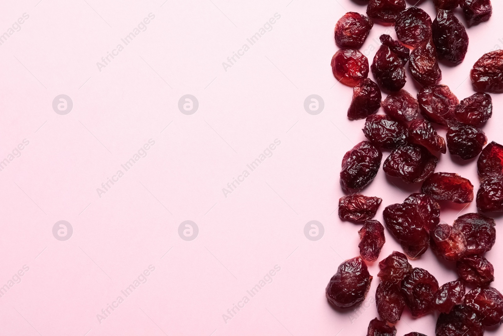 Photo of Cranberries on color background, top view with space for text. Dried fruit as healthy snack