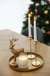 Beautiful Christmas composition with burning candles on table indoors