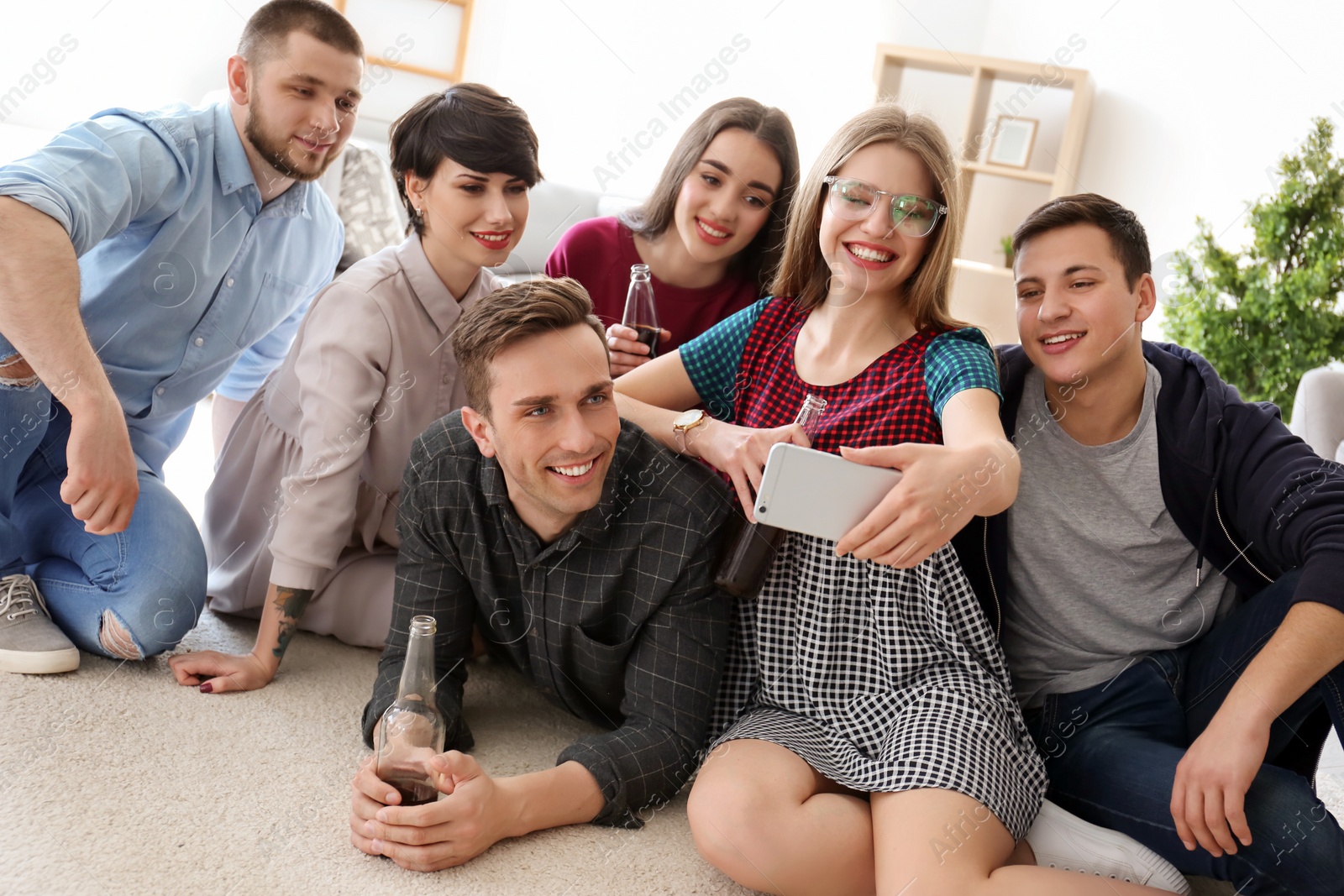 Photo of Happy friends taking selfie indoors