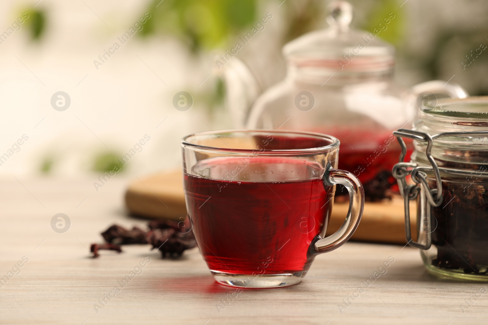 Photo of Delicious hibiscus tea on white wooden table