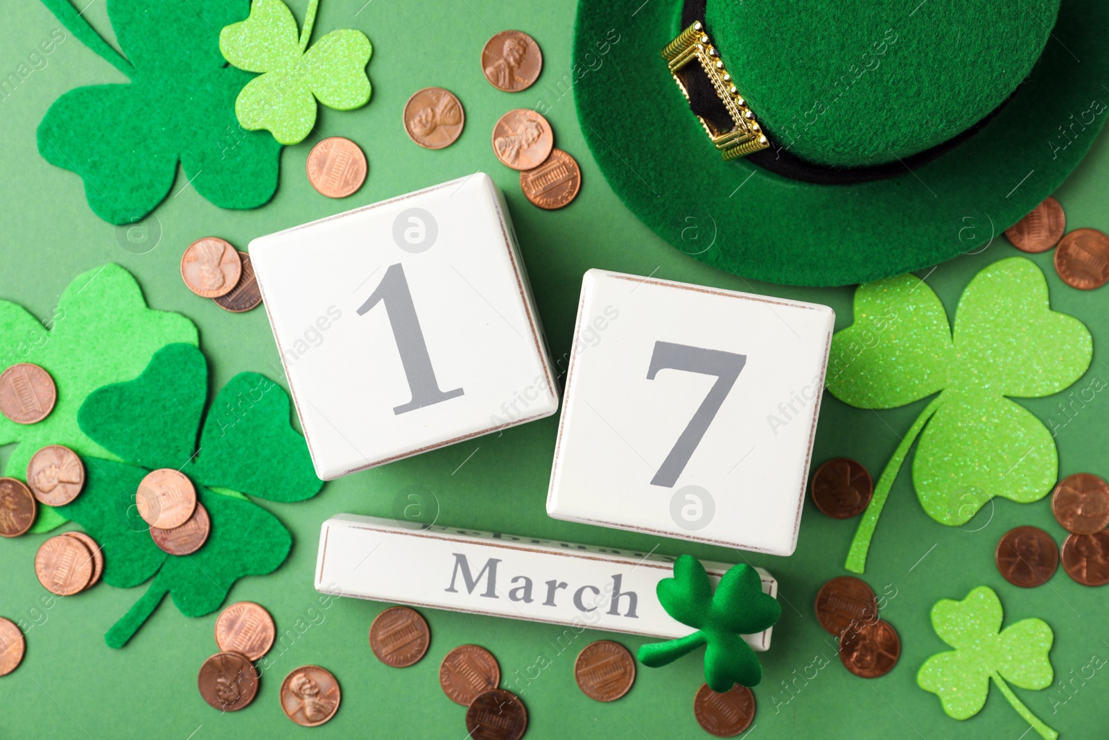 Photo of Flat lay composition with wooden block calendar on green background. St. Patrick's Day celebration