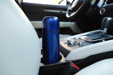 Photo of Blue thermos in holder inside of car