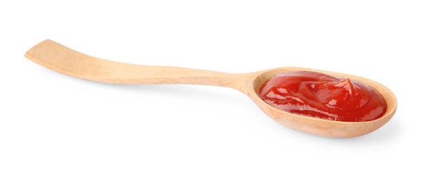 Photo of Ketchup in wooden spoon isolated on white