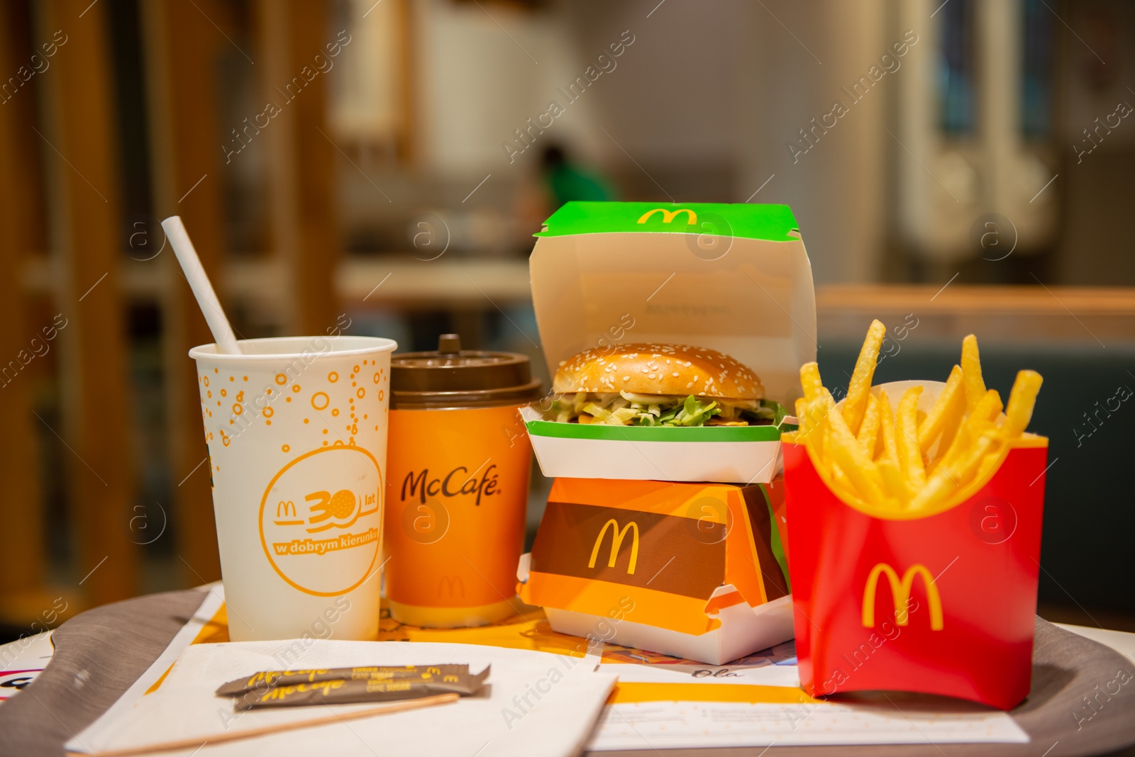 Photo of WARSAW, POLAND - SEPTEMBER 04, 2022: McDonald's French fries, burgers and drinks on table indoors