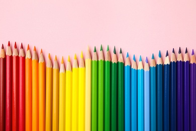 Photo of Flat lay composition with color pencils on pink background