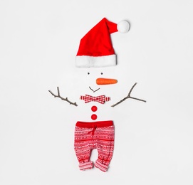 Photo of Creative snowman shape made of Santa hat and different items on white background, flat lay