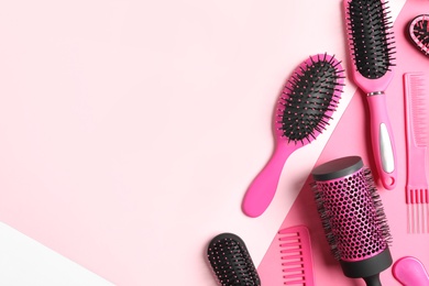 Photo of Different hair brushes and combs on color background, flat lay. Space for text