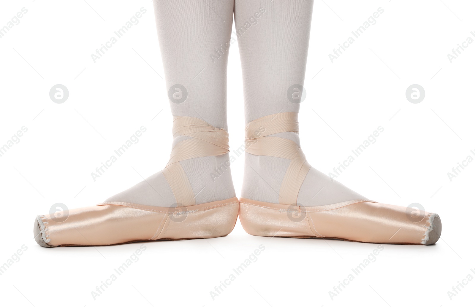 Photo of Ballerina in pointe shoes on white background, closeup